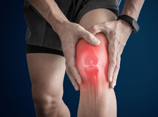 A man holding his painful knee representing joint pain